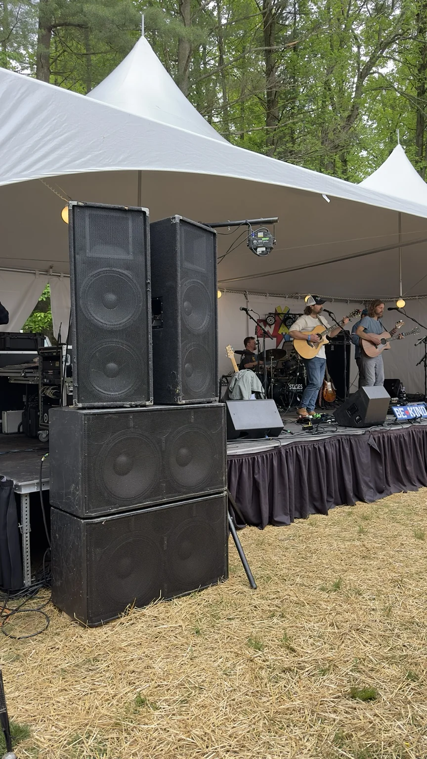 Large-format outdoor sound system beside a live band