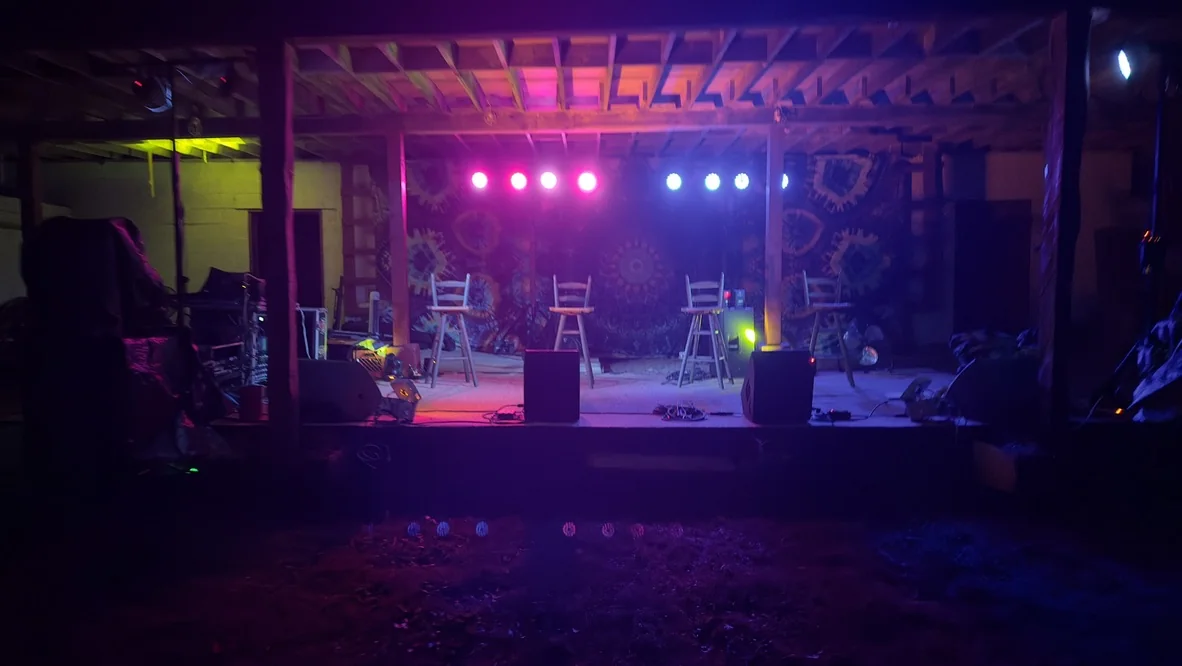 Crowded live music venue under colorful stage lighting